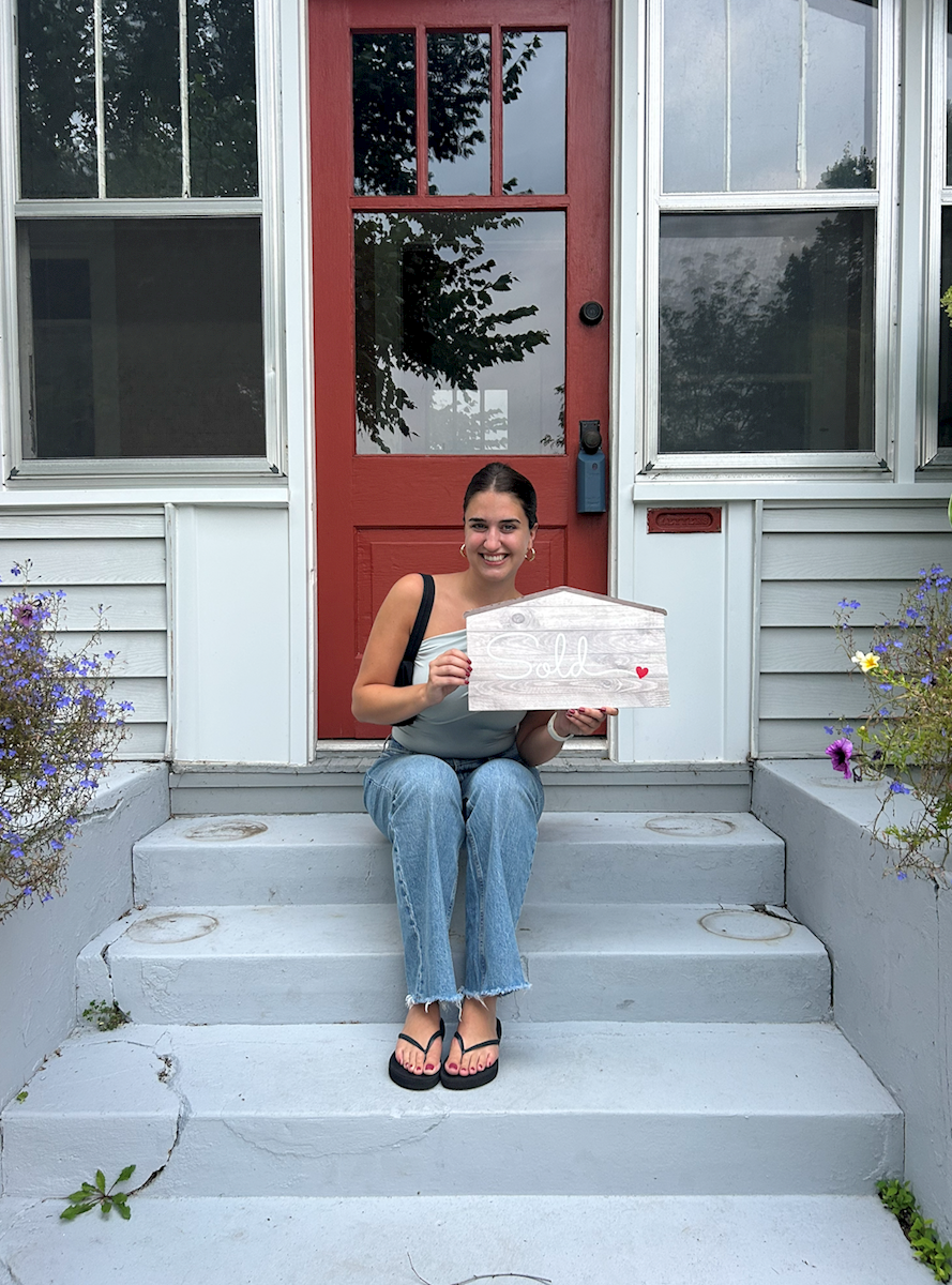 Homebuyer in front of her home.